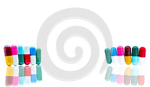 Antibiotic capsules pills in a row on white background with shad