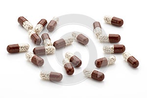 Antibiotic capsules on a white background.