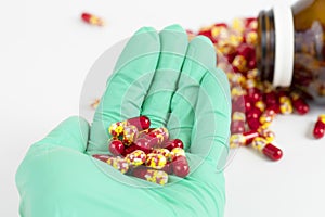 Antibiotic drug capsule on hand holding