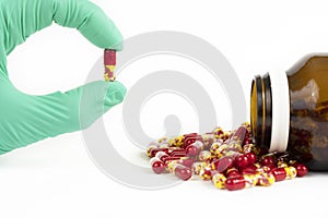 Antibiotic drug capsule and hand holding drug