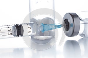 Antibiotic injection bottles with a plastic disposable syringe on a white background