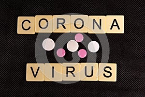 Antibiotic pills on a black background. Healthcare and medicine concept. Coronavirus inscription