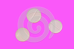 Antibiotic pills on a pink background. Healthcare and medicine concept