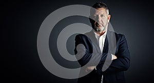 Anticipate success. Then dress for it. Studio portrait of a handsome mature businessman standing with his arms folded