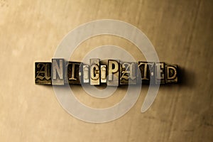 ANTICIPATED - close-up of grungy vintage typeset word on metal backdrop photo