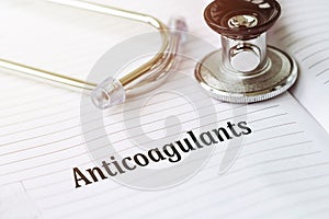 ANTICOAGULANT. Text on a medical card next to a pen stethoscope photo