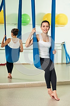 Antigravity yoga. smiling girl sitting on hammock