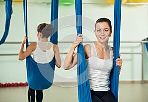 Antigravity yoga. woman sitting on hammock