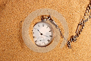 Antigue pocket watch in sand