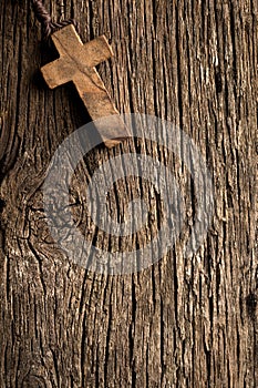 Antigue wooden cross on old wooden background