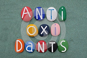 Antioxidants are compounds that inhibit oxidation, text composed with multi colored stone letters