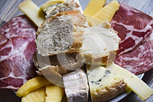Antipasti cheese board plate of bread bresaola comte