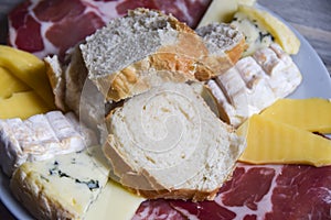 Antipasti cheese board plate of bread bresaola comte