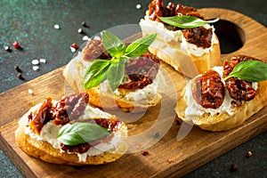 Antipasti snacks for Wine. Brushetta with Soft Cheese and Dried Tomatoes served