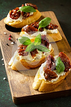 Antipasti snacks for Wine. Brushetta with Soft Cheese and Dried Tomatoes served