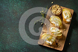 Antipasti snacks for Wine. Brushetta with Soft Cheese and Pear served