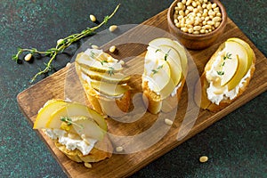 Antipasti snacks for Wine. Brushetta with Soft Cheese and Pear served