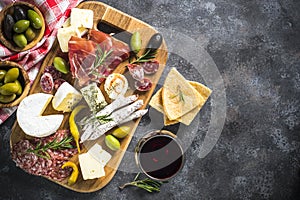 Antipasto board with sliced meat, ham, salami, cheese, olives an