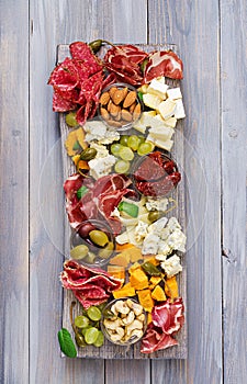 Antipasto catering platter with bacon, jerky, sausage, blue cheese and grapes