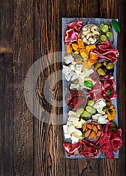 Antipasto catering platter with bacon, jerky, sausage, blue cheese and grapes