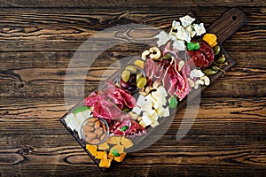 Antipasto catering platter with bacon, jerky, sausage, blue cheese and grapes