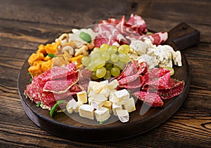 Antipasto catering platter with bacon, jerky, sausage, blue cheese and grapes