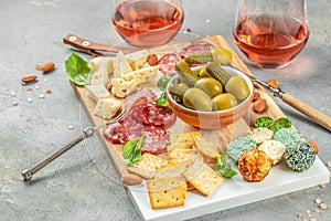 Antipasto catering platter with salami, crackers, cheese, olives and rose wine. place for text, top view