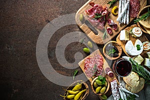 Antipasto delicatessen - meat, cheese, olives and wine on stone