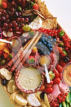 Antipasto platter with meat, chease, fruits, vegetables and nuts photo