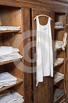 Antiquated bedroom with linen clothing