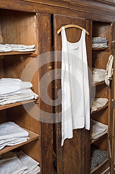 Antiquated bedroom with linen clothing photo