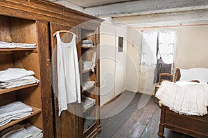 Antiquated bedroom with linen clothing photo