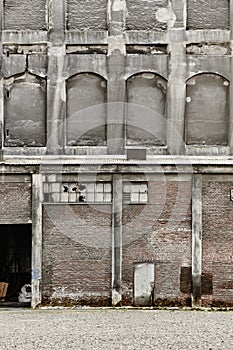 Antique abandoned brick and concrete warehouse facade. Norway