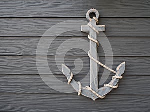 Antique anchor on wooden grey background