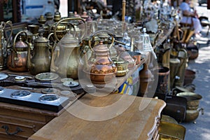 Antique antiques are sold at a flea market.Coffee turks and copper kettles.