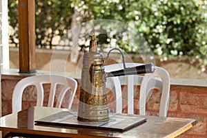 Antique arabic coffee pot on ceramic tray