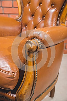 Antique armchair furniture with cushion against white wall