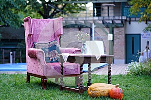 Antique armchair outdoors, in an autumnal composition