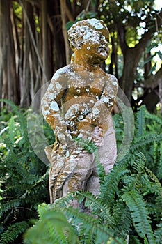 Antique baby angel statue in a garden