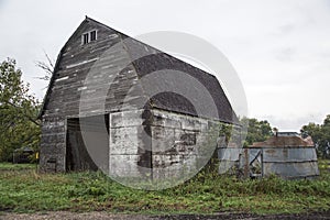 Antique barn silo gray sky trees