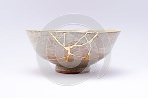 Antique beautiful bowl restored with kintsugi gold technique photo