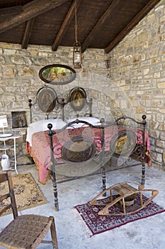 Antique bedroom in italy with wrought iron bed and bed warmer (or warming pan). photo