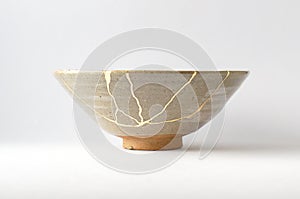Antique beige bowl repaired with the antique kintsugi real gold technique photo