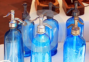 Antique blue soda syphon bottles on flea market