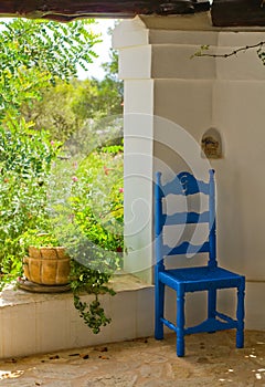 Antique Blue Wooden and Wicker Chair in a Porch