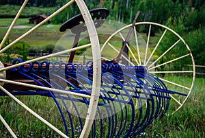 Antique blue and yellow hay rake