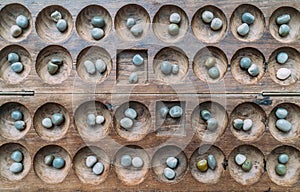 Antique Boa Mancala tradition African Board Game. Vintage Bao carved wooden Board Game. With natural baobab tree seeds Balls