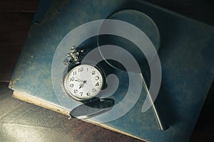 Antique book with magnifier and pocket watch