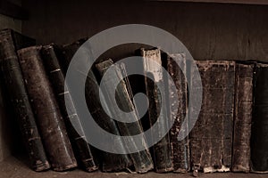 Antique books on bookshelf. Old leather bound vintage books