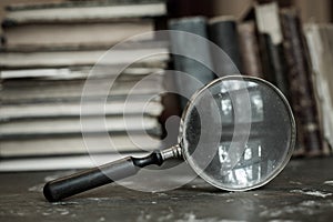 Antique books with magnifying glass